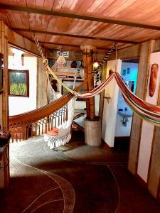 a room with a hammock in a house at Kasaguadua - RESERVA NATURAL in Salento