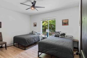 a bedroom with two beds and a ceiling fan at Luxe Mt. Rainier Lodge w/ Hot Tub-AC-Game Room in Ashford