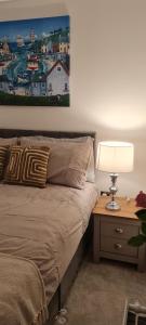 um quarto com uma cama e uma mesa com um candeeiro em Cross River em Durham