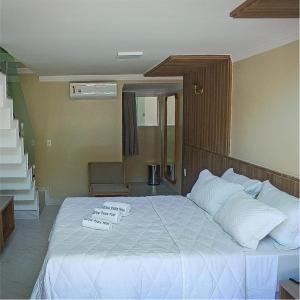 a bedroom with a bed with white sheets and pillows at Star Palace Hotel Jeri in Jericoacoara