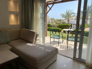 a living room with a couch and a patio with a table at Hotel studio in Sharm El Sheikh