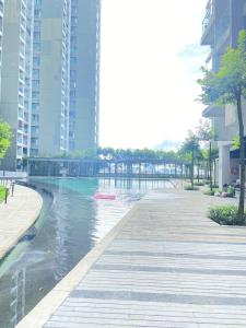 a swimming pool in a city with tall buildings at RS Homestay in Seri Kembangan