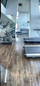 a gym with several treadmills and elliptical machines at RS Homestay in Seri Kembangan