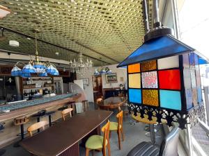 a colorful stained glass chandelier hanging in a restaurant at まちやど　Motomachi in Daigo