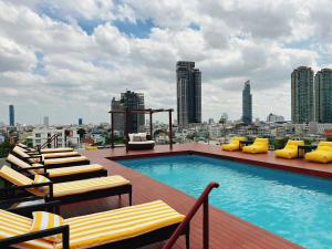 a swimming pool on the roof of a building at Miloft Sathorn Hotel - SHA Plus Certified in Bangkok