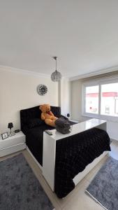 a teddy bear sitting on a bed in a bedroom at Anemon Residence in Alanya