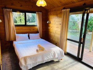 a bedroom with a bed and a large window at Sunny Beachview Homestay Auckland in Auckland
