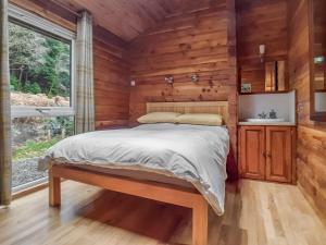 a bedroom with a bed in a log cabin at Ard Darach Lodge in Brinscall