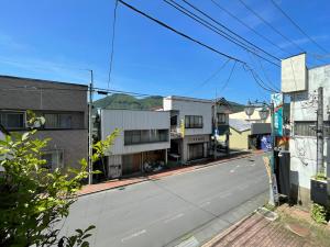 an empty street in a city with buildings at まちやど　Motomachi in Daigo