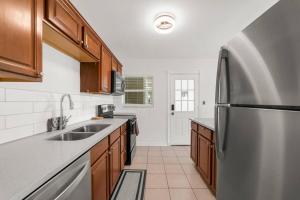 a kitchen with a stainless steel refrigerator and wooden cabinets at Spacious 3 Bedroom home in Riverside in Jacksonville