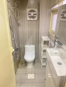 a small bathroom with a toilet and a sink at Al Muftaha Apartment in Abha