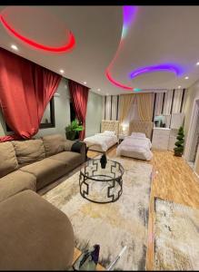 a living room with a couch and a table at Al Muftaha Apartment in Abha