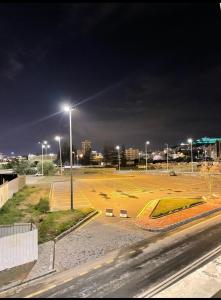 an empty parking lot at night with a street light at Al Muftaha Apartment in Abha