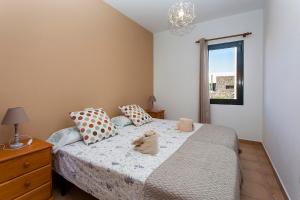 Łóżko lub łóżka w pokoju w obiekcie Vivienda Vacacional Orquidea