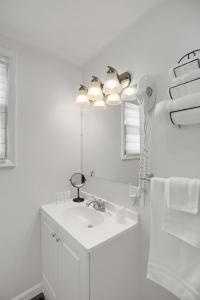 a white bathroom with a sink and a mirror at Halifax Inn in Halifax