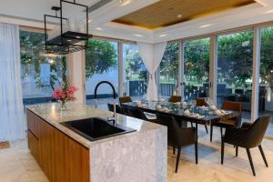 a kitchen and dining room with a table and chairs at Oceanami Villas & Beach Club Long Hai at 1, 3, 4 Bedroom & 5, 6 Bedroom Beachfront private pool in Long Hai