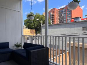 a balcony with a blue chair on a building at Perfect Location! Stylish Condo Steps Away from Nationals Stadium and Navy Yard in DC's Southwest Gem in Washington, D.C.