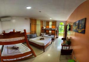 a room with two bunk beds and a couch at White Summerville Tourist Inn in Busuanga +89 photos