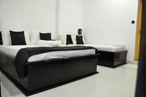 a black and white bed in a room at Villa Hotel in Trincomalee