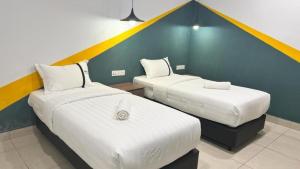 Postel nebo postele na pokoji v ubytování Smile Hotel Klang Bukit Tinggi