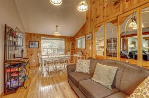 a living room with a couch and a dining room at Lovely waterfront private cottage with hot tub in Kawartha Lakes in Head Lake
