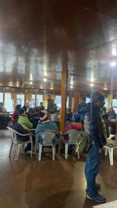 a man standing in a room with a group of people at Sherpa Lodge in Lobujya