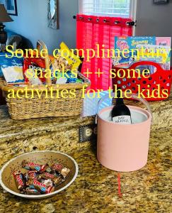 a container of some snacks and a bowl of candy on a counter at REDUCED Now avail May 27 thru June 4 , Patio, Pool, 4 Miles to Everything ! Spacious Condo Stocked with all You Need! in Myrtle Beach