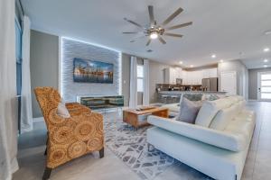 a living room with a couch and a dining room at 9 Bedroom Family Friendly Retreat - Private Pool in Kissimmee