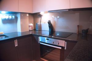 a kitchen with a stove and a counter top at Luxury London flat 5 min walk to Tube Underground in Hendon