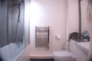 a bathroom with a toilet and a sink and a shower at Luxury London flat 5 min walk to Tube Underground in Hendon