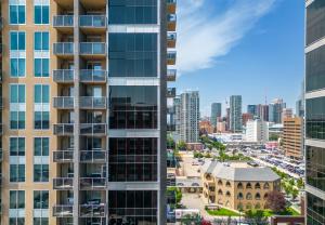 an aerial view of a tall building with a city at Chic 2BR Condo in Vibrant Downtown Calgary in Calgary