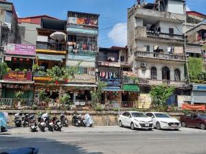 a group of motorcycles parked in front of a building at Rising Dragon Hotel in Hanoi