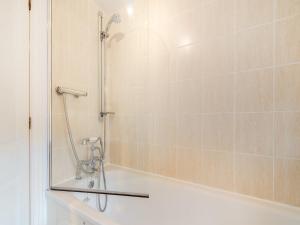 a shower in a bathroom with a tub and a mirror at Raven Cottage in Barnard Castle