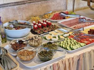 a buffet with many different types of food on a table at SanMari in Daugavpils