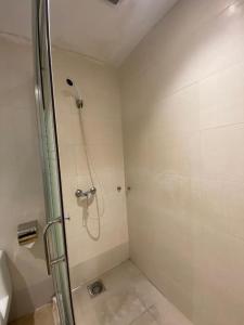 a bathroom with a shower with a glass door at Merchant Express Bintulu in Bintulu