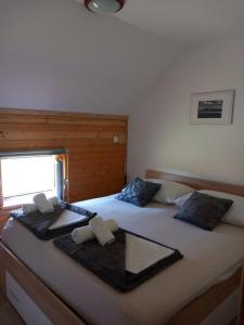 um quarto com uma cama grande e toalhas em Green cottage em Blidinje