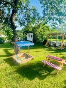 a park with a play area and a tree at Casa De Sub Deal in Densuş