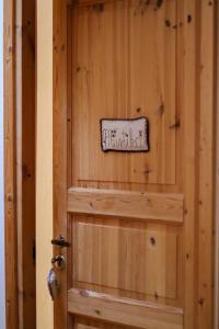 a wooden door with a sign on it at Samblatalu Homestay in Laulasmaa