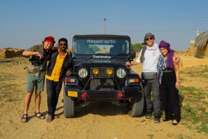 a group of people standing in front of a jeep at Hotel Pleasant Haveli - Only Adults in Jaisalmer