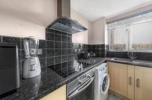 a kitchen with a appliance on a counter top at London flat next to DLR station with free parking in London