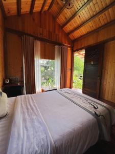 a large bed in a room with a window at SORA HOMESTAY in Pleiku
