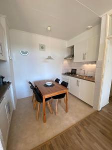 a kitchen and dining room with a table and chairs at Texel-De Koog 116 in De Koog
