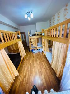 two bunk beds in a room with wooden floors at Adventure Riders Mongolia in Ulaanbaatar