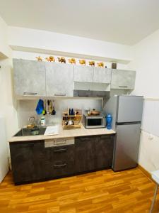 a kitchen with a sink and a refrigerator at Adventure Riders Mongolia in Ulaanbaatar
