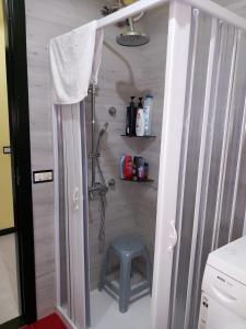 a shower with a blue stool in a bathroom at Appartamenti Villa Wanda in Palmi +64 photos