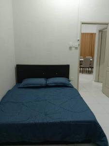 Un ou plusieurs lits dans un hébergement de l'établissement Friendly Homestay Malacca