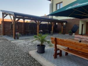 a wooden bench sitting in front of a building at penzionMoravia in Moravská Nová Ves