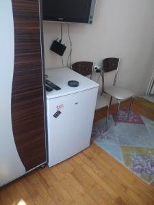 a white refrigerator with a television on top of it at Opium otel in Afyon