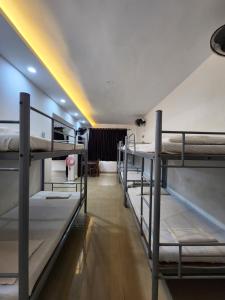a group of bunk beds in a room at All Seasons Guest House I Rooms & Dorms in Madgaon