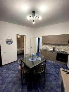 a kitchen with a table and chairs in a room at Casa Gabry e Lory in Fort Village